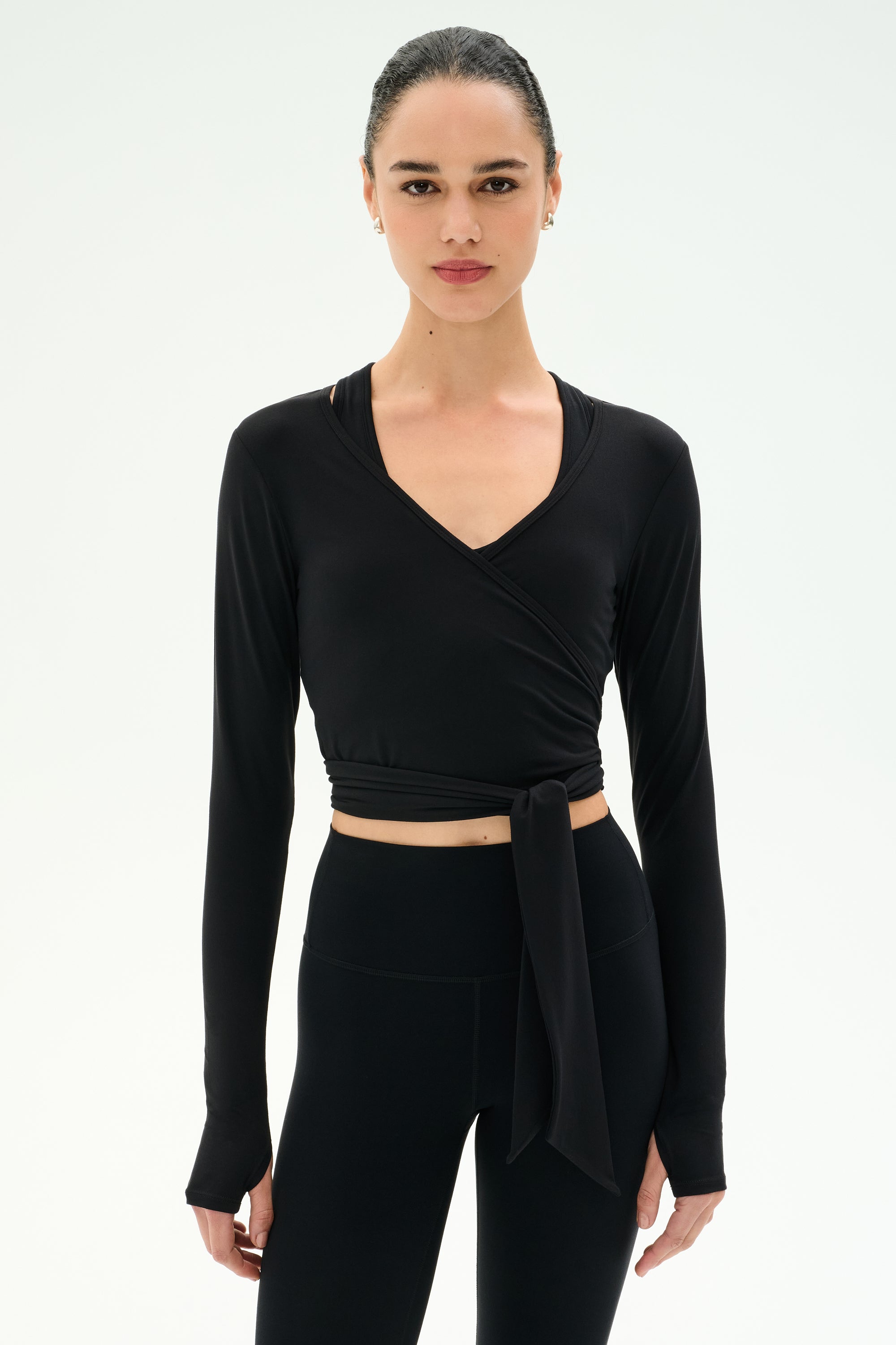 Official SPLITS59 image of the Bella Airweight Lite Wrap in black layered over a black activewear set