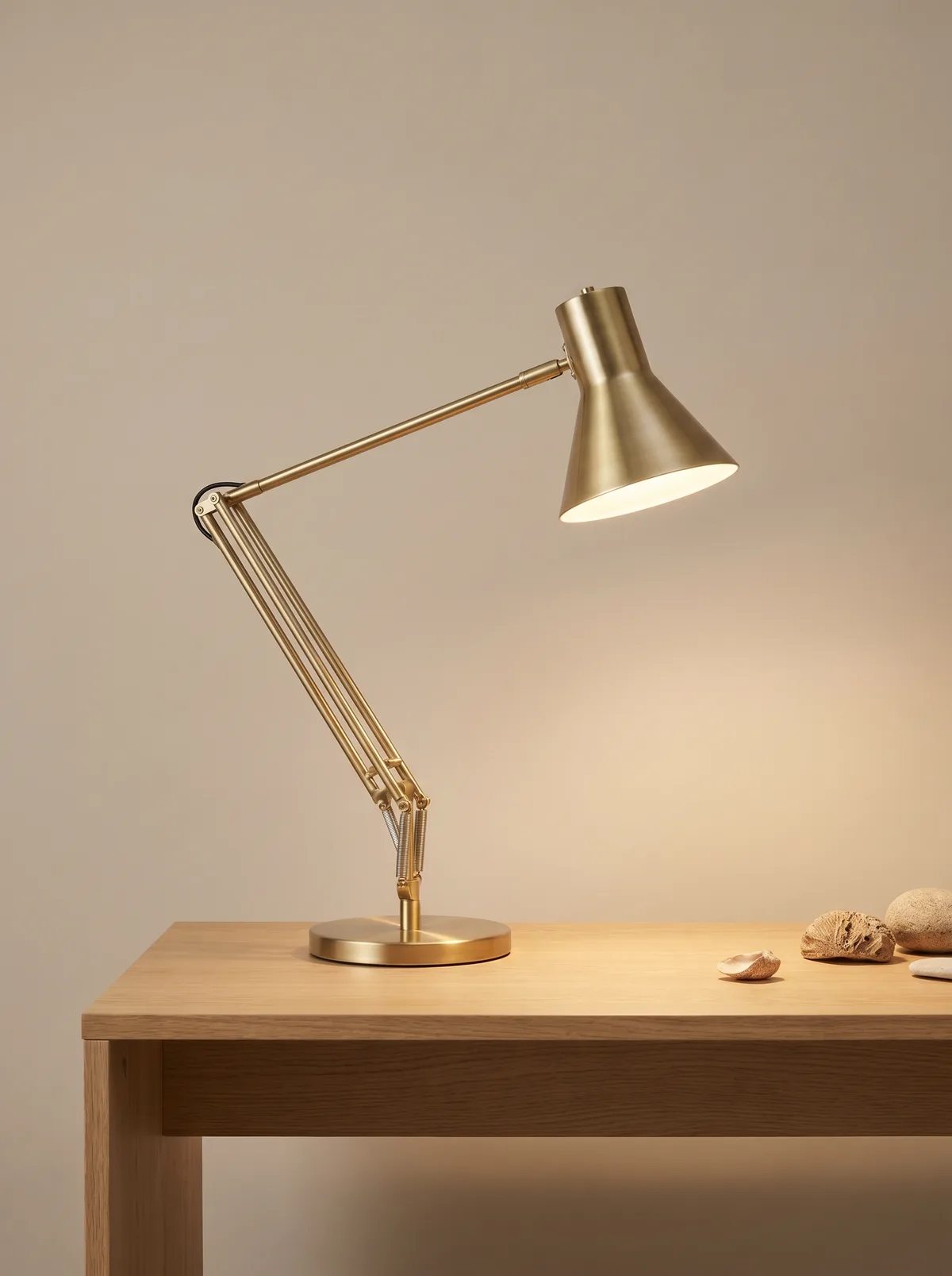 Brass architectural task lamp on a wood desk