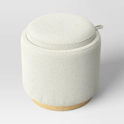 Round upholstered storage ottoman